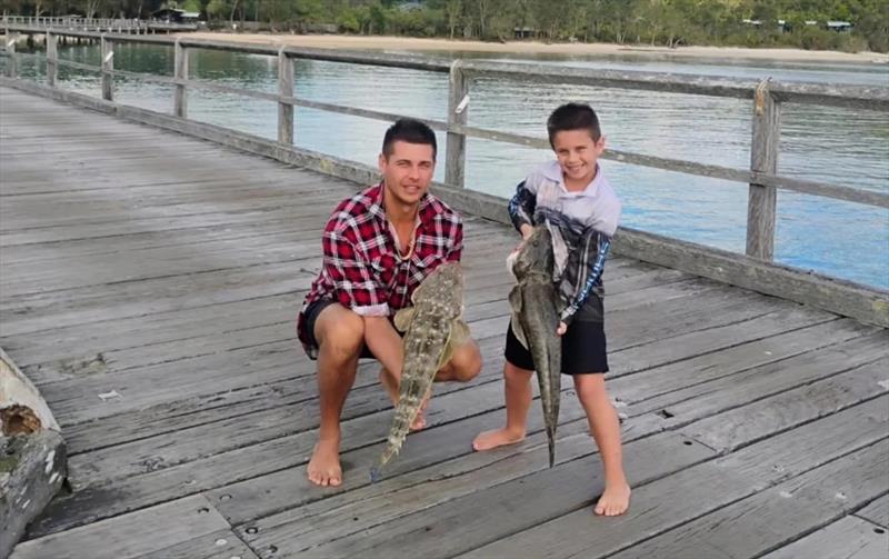 Great father-son moments on Kingfisher's jetty, as Brock and Kingy got amongst the big flatties - photo © Fisho's Tackle World Hervey Bay