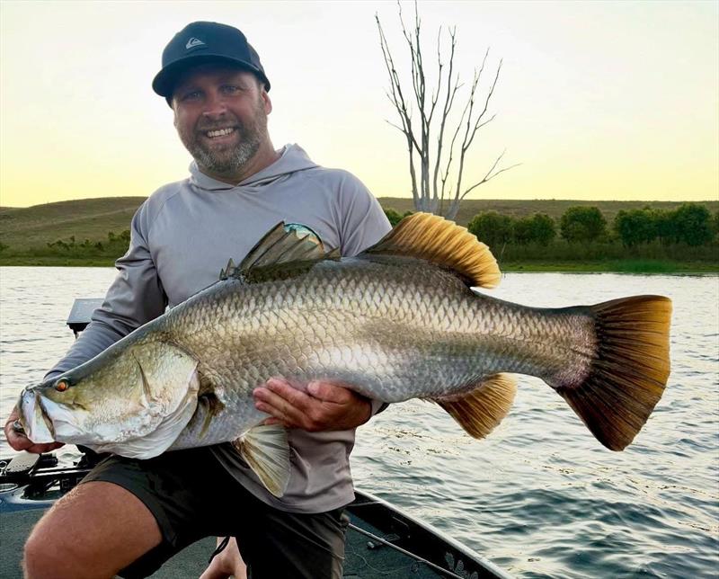 Mark with an example of the average barra Mondy fishos are catching these days - photo © Fisho's Tackle World Hervey Bay