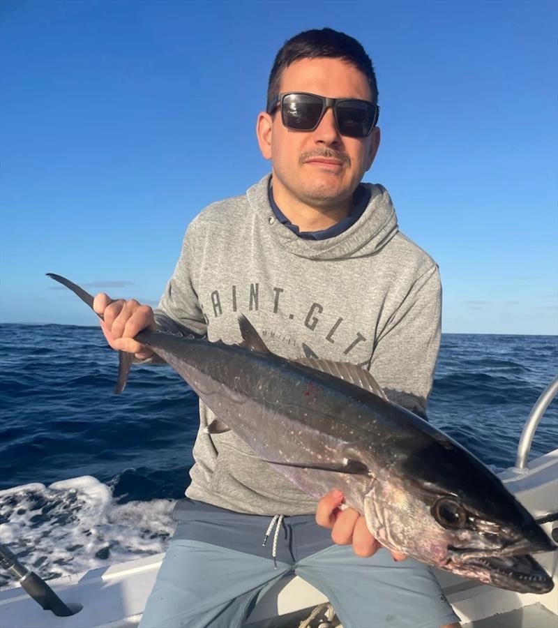 A cute little dogtooth tuna Mick's crew member picked up on the Sandy Cape Shoals. Proof once again that there are doggies out there - photo © Fisho's Tackle World Hervey Bay