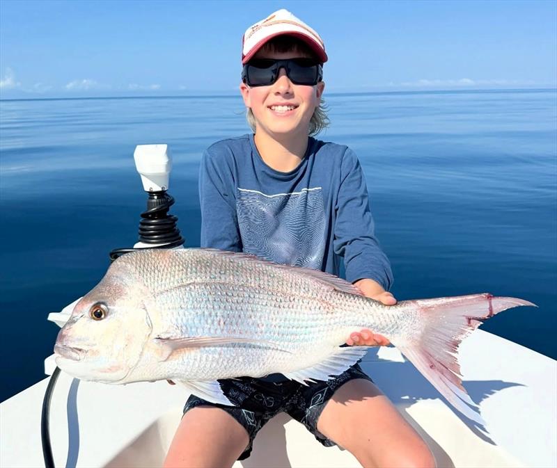 A lovely snapper was the highlight of this young lad's day on the water. Look for them in the northern bay of offshore once the weather settles - photo © Fisho's Tackle World Hervey Bay