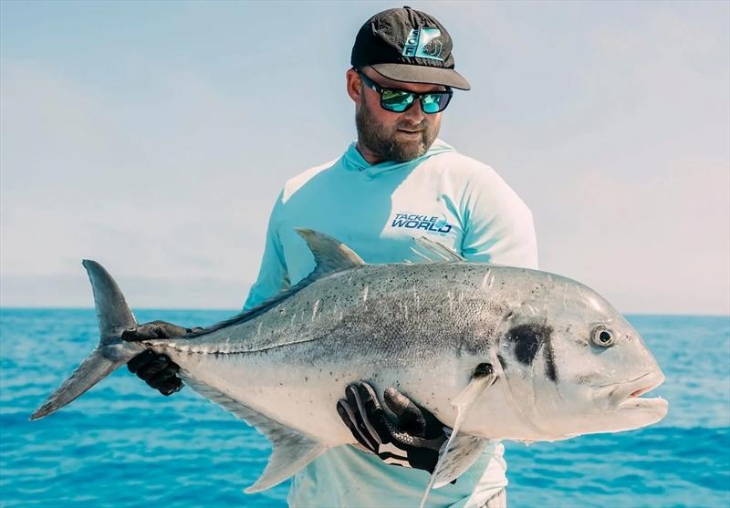 Shaun, the skipper of Saltwater Playground Charters with a recent GT capture from the offshore shoal country - photo © Fisho's Tackle World Hervey Bay