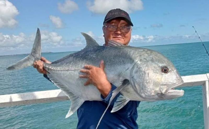 Urangan Pier regular, Colin, with a sample of the big GTs terrorising the baitfish and mackerel out the deep end at present - photo © Fisho's Tackle World Hervey Bay