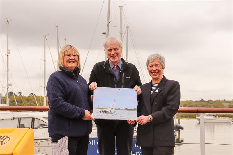 (l-r) Winner Maggie White with Lord Montagu and boat owner Joanne Husband with the print photo copyright Jane Riddiford taken at  and featuring the Folkboat class