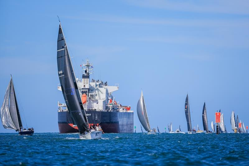 Passage Spinnaker Div 1 fleet sailing past a tanker - Festival of Sails 2025 photo copyright Salty Dingo taken at Royal Geelong Yacht Club and featuring the IRC class