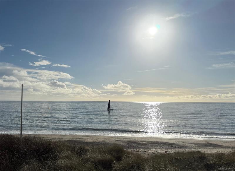 Pwllheli Winter Series Weekend 2 - Lightning finishing the race, watched by spectators along the beach - photo © Vicky Cox