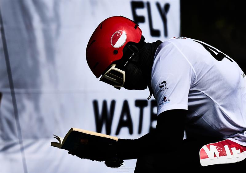 Maeder with his nose in a book - 2024 KiteFoil World Series Austria photo copyright IKA media/ Robert Hajduk taken at  and featuring the Kiteboarding class