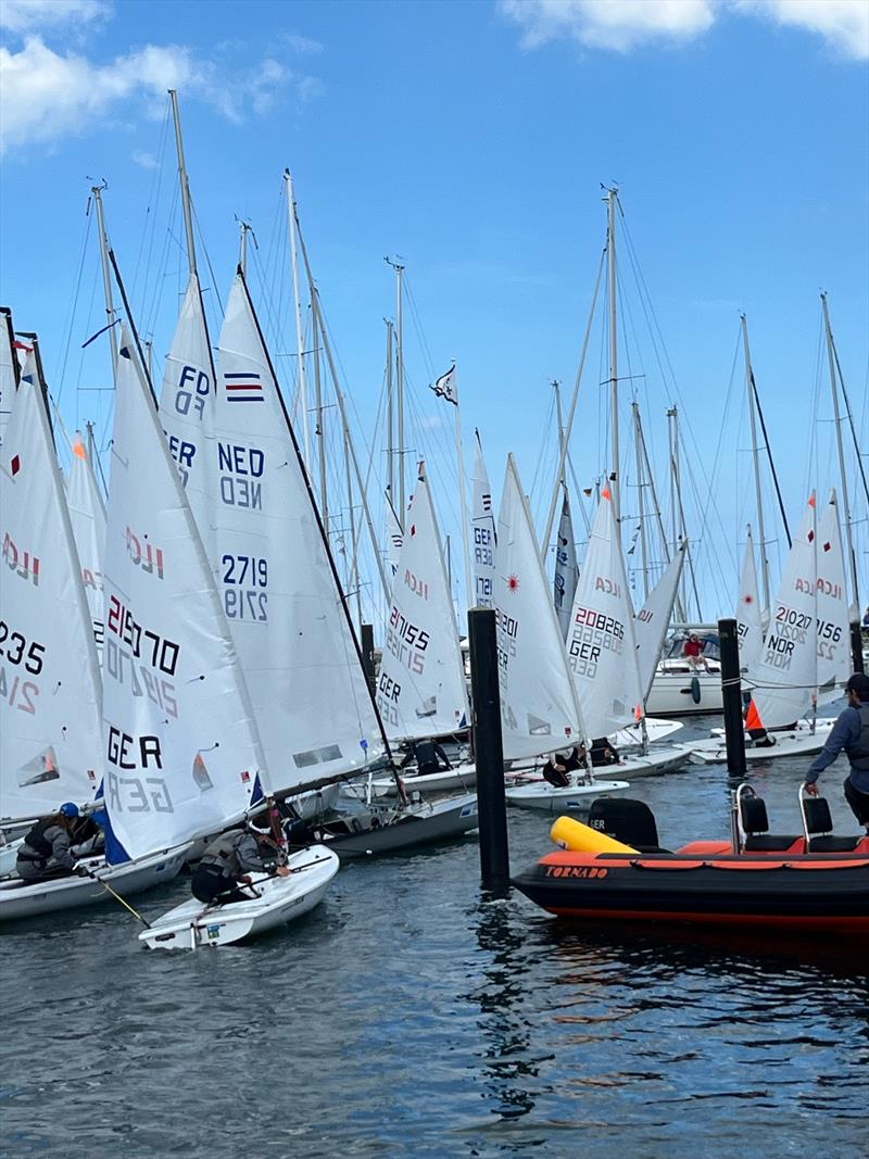 An on-water traffic jam on Saturday during Kieler Woche when five fleets are released to launch at once photo copyright Martin Pascoe taken at Kieler Yacht Club and featuring the ILCA 6 class