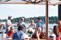 Gathering under Tuuci shade on the waterfront - 2026 M32 U.S. National Championship &copy; Hannah Lee Noll