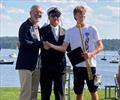 © WMRT Left to right, Tom Camp, Congressional Cup 2027 Chair, Julian Fisher II, Commodore Seawanhaka Corinthian Yacht Club, Josh Hyde, winning skipper of the 2026 Grand Slam © WMRT