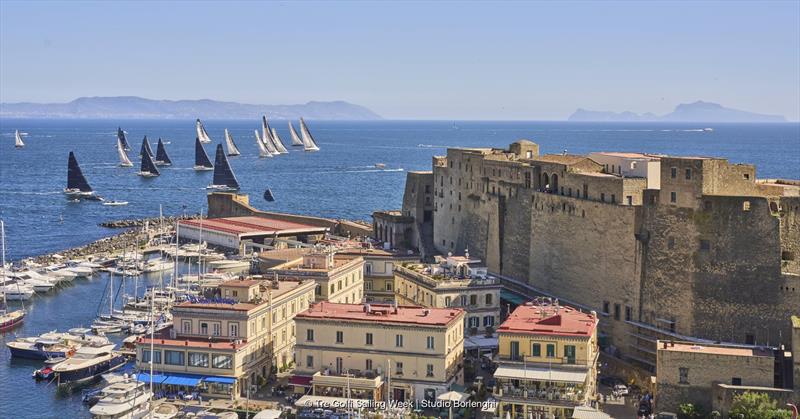 The fleet sets sail from Naples' Porticciolo di Santa Lucia and its famous Castel dell'Ovo - photo © Tre Golfi Sailing Week / Studio Borlenghi