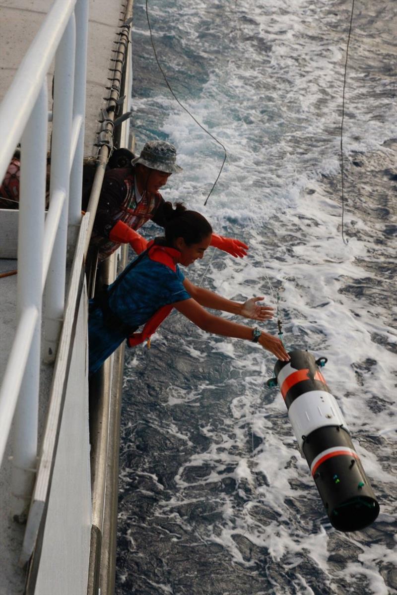 Holly and the boat crew deploy an acoustic recorder - photo © NOAA Fisheries