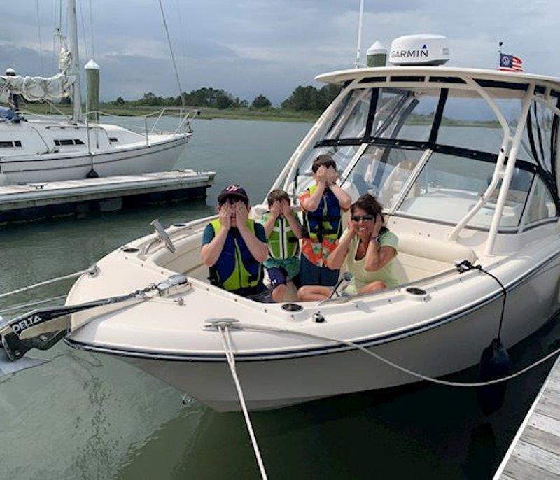 It's all fun and games on the boat as Maryanne and the grandchildren, Joseph Jr., Michael, and George, play around to the signs for `see no evil, hear no evil, speak no evil.` photo copyright Grady-White taken at 