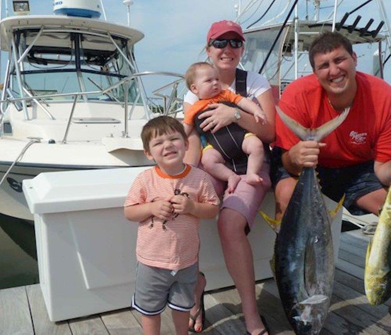 Ernie's and Maryanne's son Joseph (right) holds the day's catch while their daughter-in-law, Kristin, holds onto George and Joseph Jr. (left). - photo © Grady-White