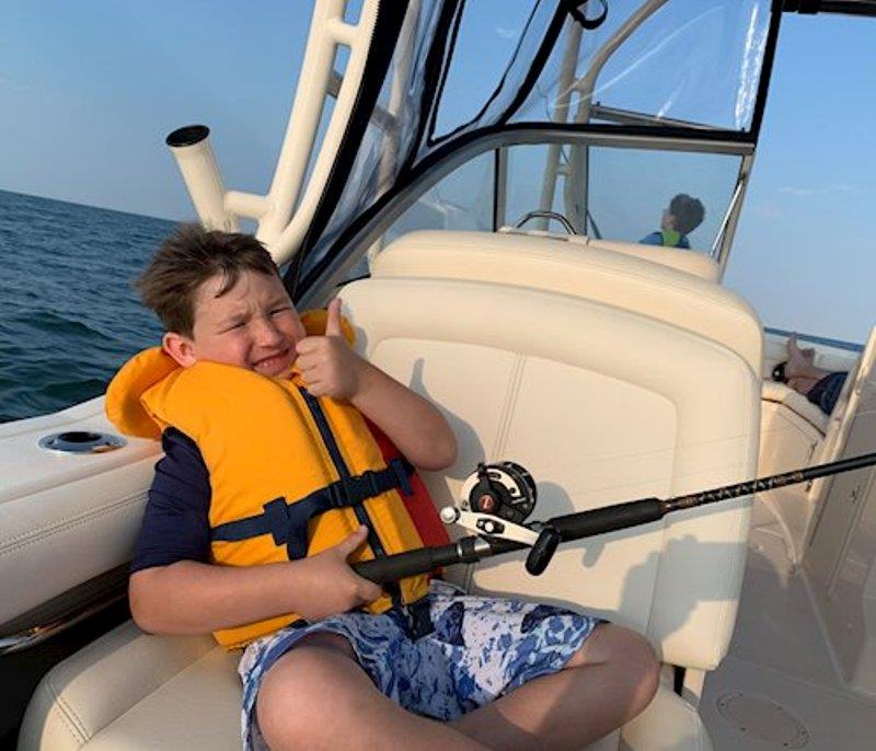 Michael, the youngest grandson, gives a thumbs up, letting everyone know he's all set to catch a big one on their new Freedom 235 photo copyright Grady-White taken at 