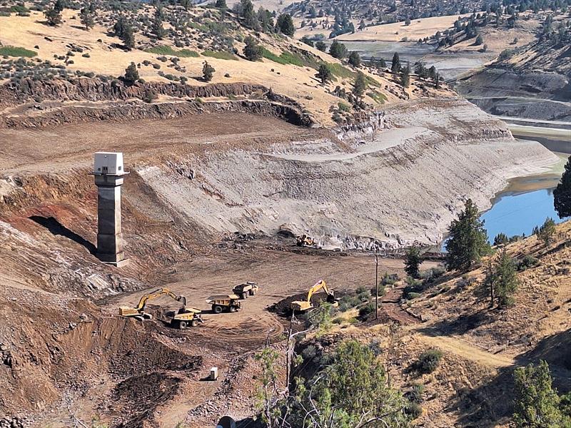 Excavators and other equipment disassemble Iron Gate Dam on the Klamath River. The removal of Iron Gate and other dams will reopen hundreds of miles of historic habitat to salmon. A new monitoring program will track their return - photo © Bob Pagliuco / Office of Habitat Conservation