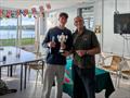 Event organiser Richard Lambert presents Oli Facques with the Start Racing Course Regatta Trophy © BBSC