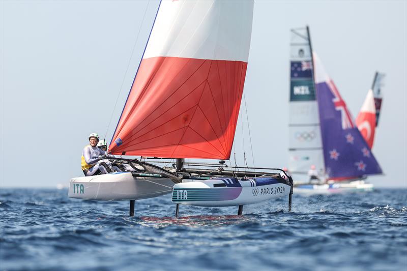 Micah Wilkinson & Erica Dawson (NZL) trail Ruggero Tita & Catarina Banti (ITA) - Mixed Multihull - Nacra17 - Paris 2024 - Marseille - August 6, 2024 photo copyright World Sailing / Sander van der Borch taken at Yacht Club de France and featuring the Nacra 17 class