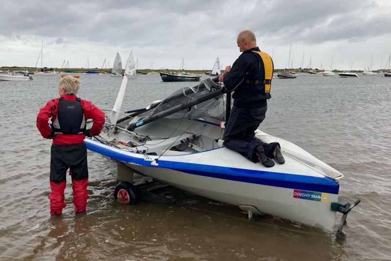 Ian and Alex Gore and the tale of the broken mast - North West Norfolk Week 2023 day 4 photo copyright George Finch taken at Brancaster Staithe Sailing Club and featuring the National 12 class