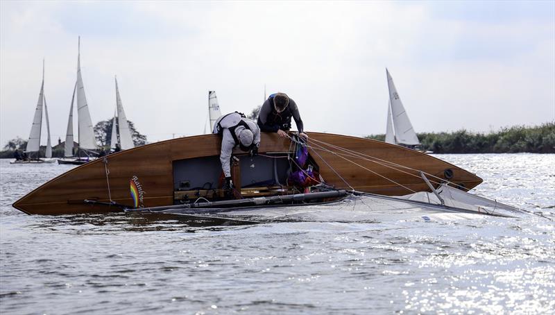 Rainbow Trout capsizes during the Norfolk Punt Athene Cup photo copyright Robin Myerscroft taken at Norfolk Punt Club and featuring the Norfolk Punt class