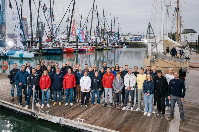 All skippers but Boris Herrmann are posing for the official group picture on pontoons of the Vendee Globe, on October 20, in Les Sables d'Olonne, France photo copyright Vincent Curutchet / Alea taken at  and featuring the IMOCA class