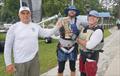 Larry Wagner, Commodore, presents the ritual mug of beer to Pete Hampshire and skipper Eric Roberts, winner of the 69th Mug Race © Image courtesy of the Mug Race