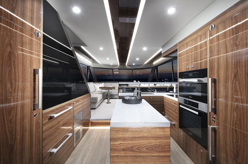 Pantry to the left and fridge to the right, with the great new backward facing stairs behind the black panel - New Maritimo M55 - photo © Maritimo