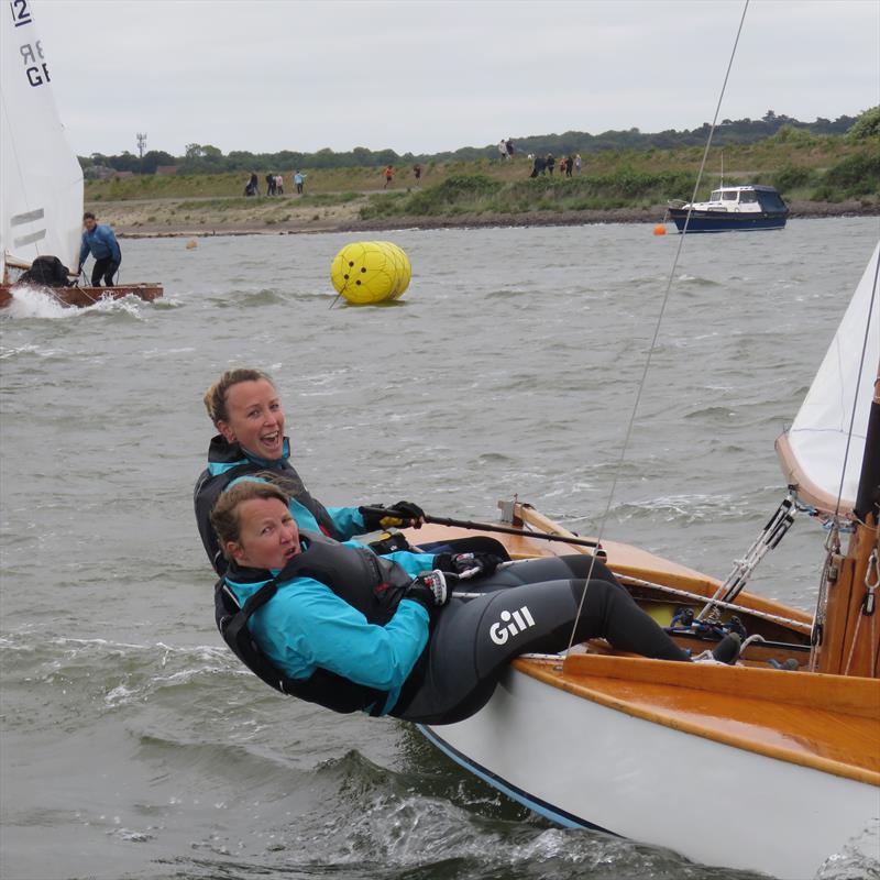 Agony & ecstasy! The Spink sisters, helm Claudia smile and crew Kiki in pain during the British 12 Sq M Sharpie Nationals at Wells Sailing Club photo copyright James Case taken at Wells Sailing Club and featuring the Sharpie class