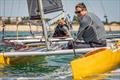 William Dawson can't resist a smile as he narrowly sneaks over the line ahead of Dan Jarman on day 2 of the Unicorn and A Class Catamaran Nationals at Hayling Ferry SC © Gordon Upton / www.guppypix.com