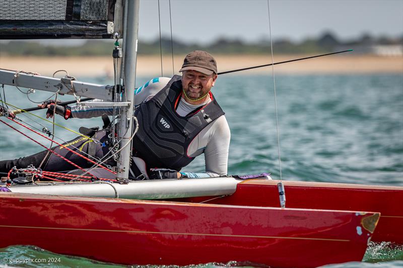 Clive Wright just enjoying his sailing during the Unicorn and A Class Catamaran Nationals at Hayling Ferry SC photo copyright Gordon Upton / www.guppypix.com taken at Hayling Ferry Sailing Club and featuring the Unicorn class