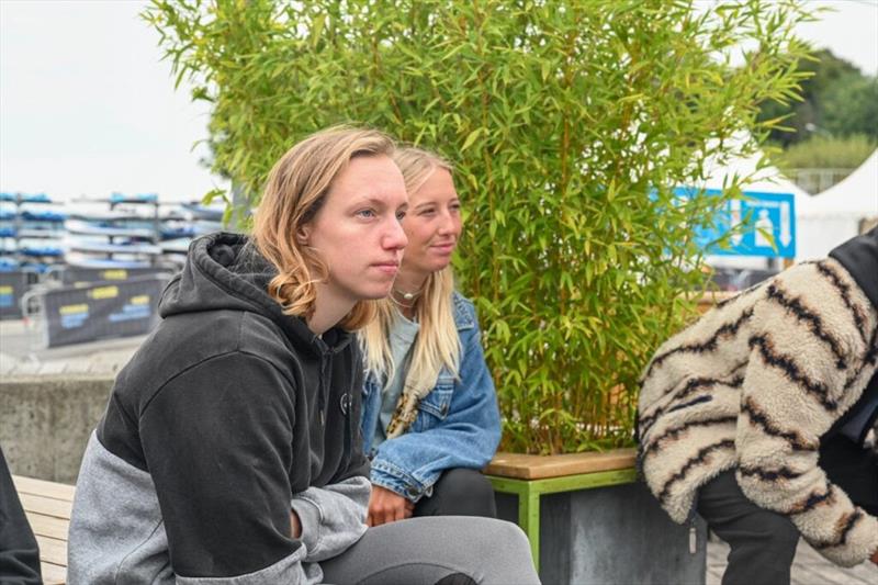 Maaike Huvermann and Lisa Kloster focused at the Skippers Meeting - 2024 Freestyle Pro Tour Geneva day 1 photo copyright PROtography Official taken at  and featuring the Windsurfing class