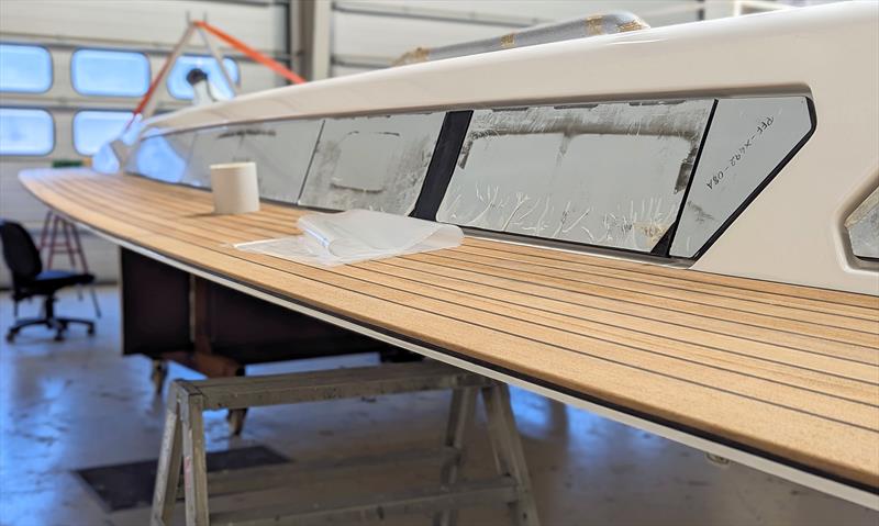 Working on the deck fit-out before bonding to the hull - photo © Mark Jardine